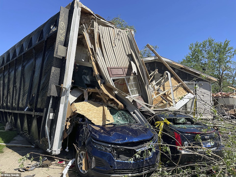 Kalamazoo County Sheriff Richard Fuller said more than a dozen mobile homes in Pavilion Township were 'totally destroyed.' At least 16 people, he added, were injured there, though the injuries were not life-threatening. 'The clean-up efforts are tremendous. We're looking at homes throughout this community that are totally gone, they've been demolished,' Fuller said. Homes were completely flipped over and cars were smashed by debris and trees moved by the storm. A home where seven people were living 'is totally on its top,' he said. 'They were able to self-rescue and get somewhere safe and came back today.' 'We found homes in the roadway,' the sheriff said late on Tuesday. 'We found homes in neighbors' homes. We found large trees in homes.'