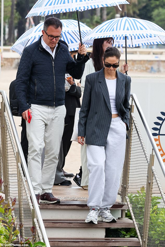 Shanina received a helping hand off a male companion who held up an umbrella to cover her from the rain