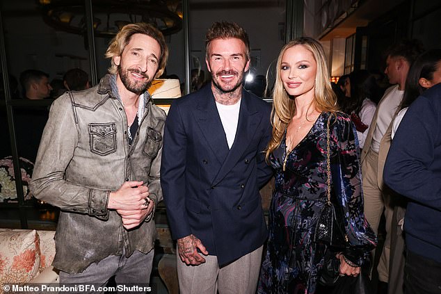 Actress and model Georgina Chapman looked incredible in a black plunging dress as she posed with Adrien Brody