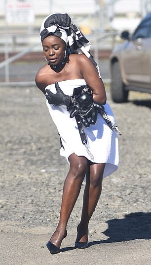 A sudden gust of wind appeared to lift up the side of her perilously short ensemble