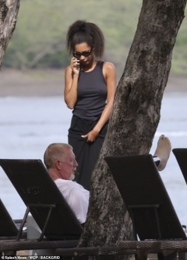 She accessorised with dark shades and chatted on the phone while wearing her hair in pretty curls