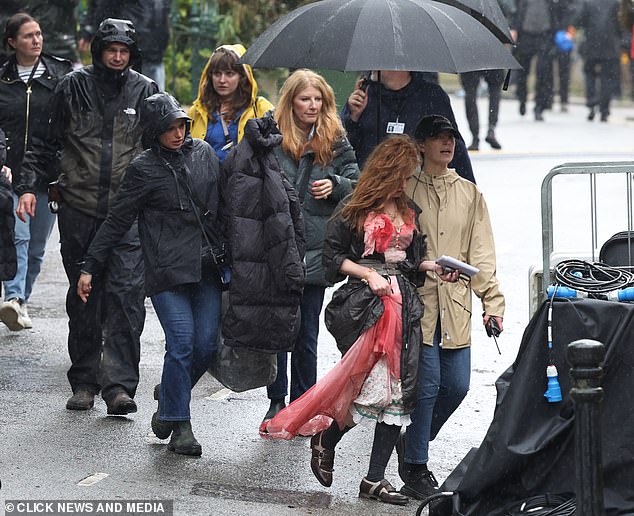 Isla was dressed in a quirky pink dress, black knee-high socks and brown slip-on shoes while chatting to crew