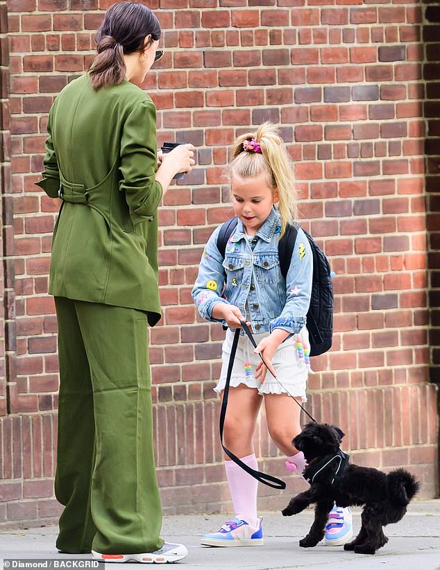 The little girl got to take her turn at leash duty too, keeping a watchful eye on her pet as it scampered about on the sidewalk