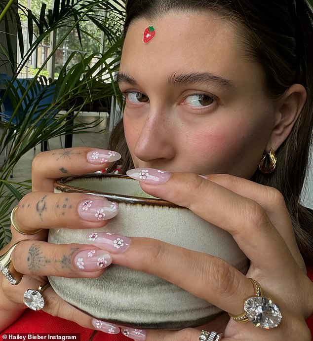 In a cryptic social media post on Friday, the 27-year-old wrote, 'Little cherry blossoms on my nails, little cherry blossom in my belly' - leading fans to believe she's having a girl