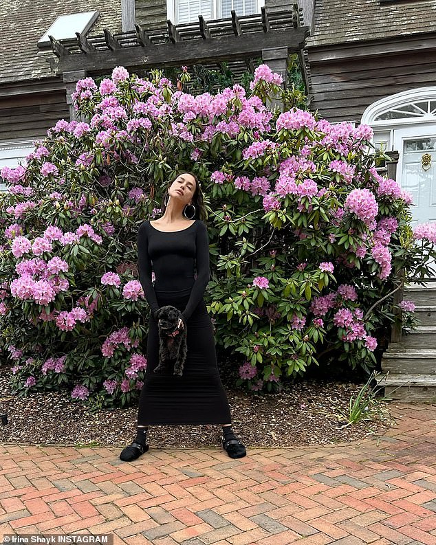 Irina also posed in front of a large purple flower bush in another fun snap