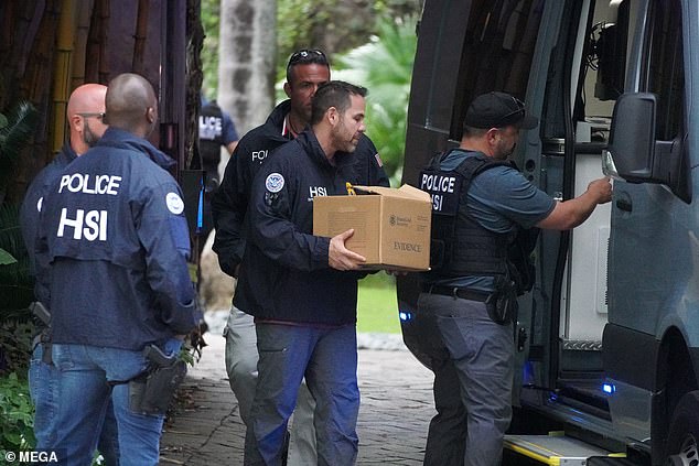Law enforcement were removing boxes of evidence and a laptop from Diddy's Star Island mansion in Miami Beach