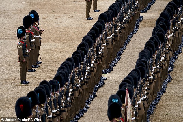 Troops of the Household Division take part in the Brigade Major's Review, the final rehearsal of Trooping the Colour, on Horse Guards Parade in London yesterday