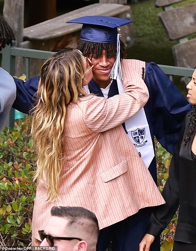 Heidi looked every inch the proud parent as she gave Henry a kiss on the cheek