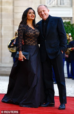 The French businessman, who tied the knot with Salma in 2009, matched his wife in a plain navy suit, shirt and tie