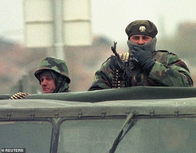 Yugoslav army soldiers stand atop of an army truck March 24 1999