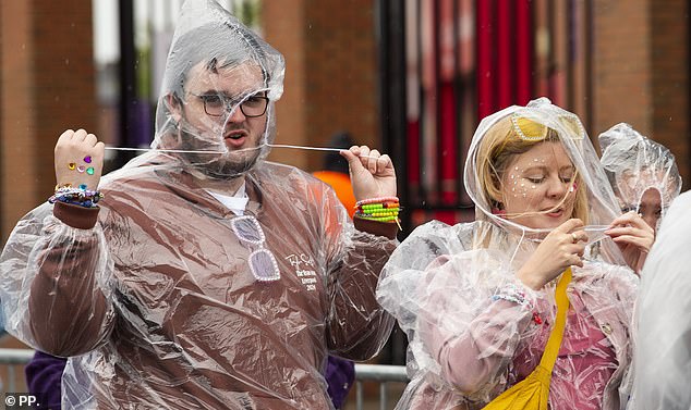 Taylor Swift fans brave the rain and wear poncho's outside Anfield