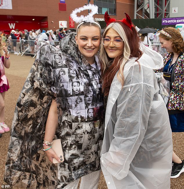 One fan is seen wearing a Taylor-Swift themed poncho to protect herself from the rain