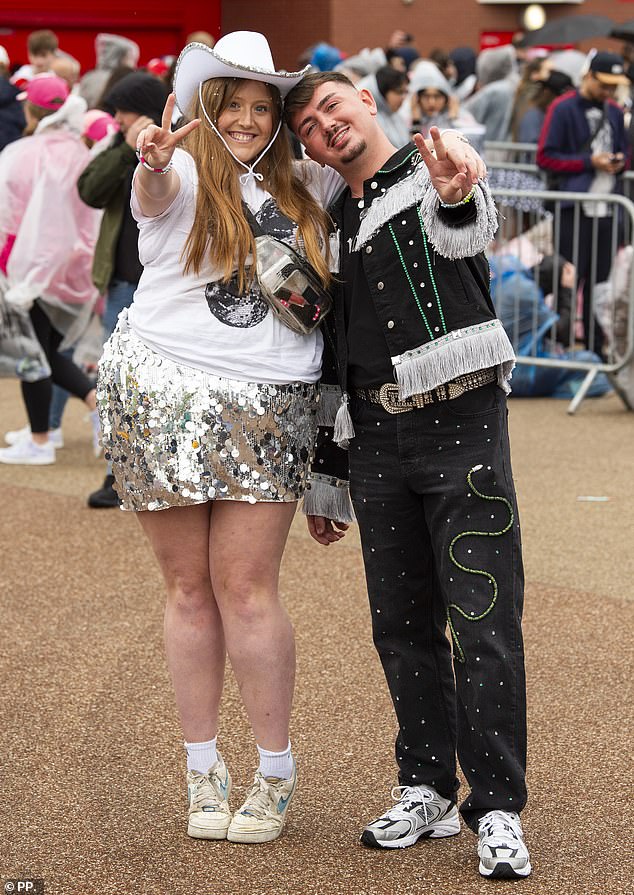 Two Taylor Swift fans pose for a photo while waiting for the Taylor Swift concert to start