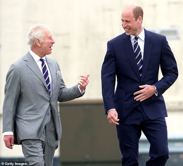 MAY 13: King Charles III and Prince William, Prince of Wales share a joke during the official handover in which King Charles III passes the role of Colonel-in-Chief of the Army air corps to Prince William