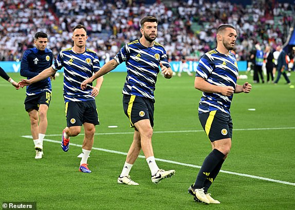 Soccer Football - Euro 2024 - Group A - Germany v Scotland - Munich Football Arena, Munich, Germany - June 14, 2024 Scotland's John McGinn, Grant Hanley and teammates during the warm up before the match REUTERS/Angelika Warmuth