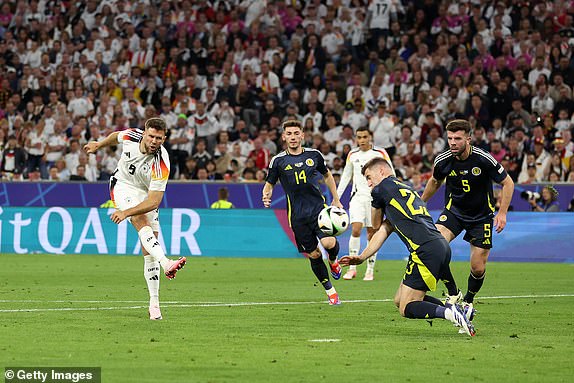 MUNICH, GERMANY - JUNE 14: Niclas Fuellkrug of Germany scores his team's fourth goal whilst under pressure from Kenneth McLean of Scotland during the UEFA EURO 2024 group stage match between Germany and Scotland at Munich Football Arena on June 14, 2024 in Munich, Germany. (Photo by Carl Recine/Getty Images)