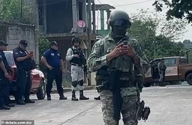 Authorities in the southeastern Mexico city of Macuspana stand near the clandestine bar where six people were murdered and nine were wounded after three alleged men enter the business and attacked the victims with knives