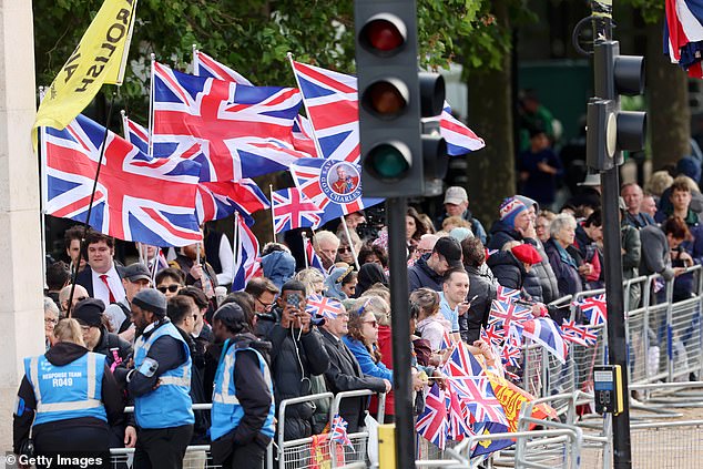 Members of the public gather on The Mall ahead of Trooping the Colour this morning