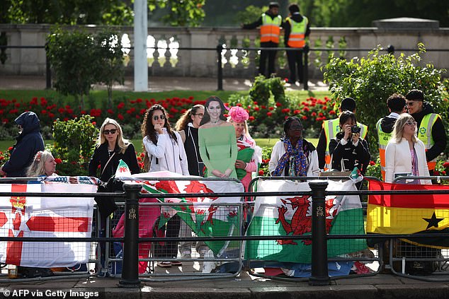 Royal fans on the The Mall with a cardboard cutout of the Princess of Wales this morning