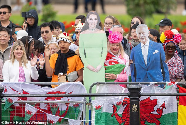 Royal fans on the The Mall with cardboard cutouts of the Princess of Wales and the King today