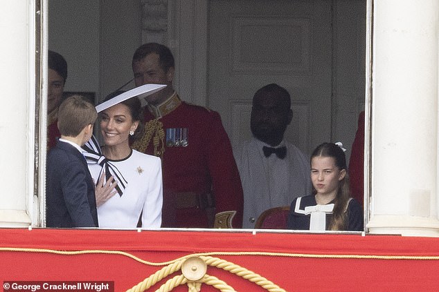 The Princess of Wales speaks with Prince Louis as they watch Trooping the Colour today