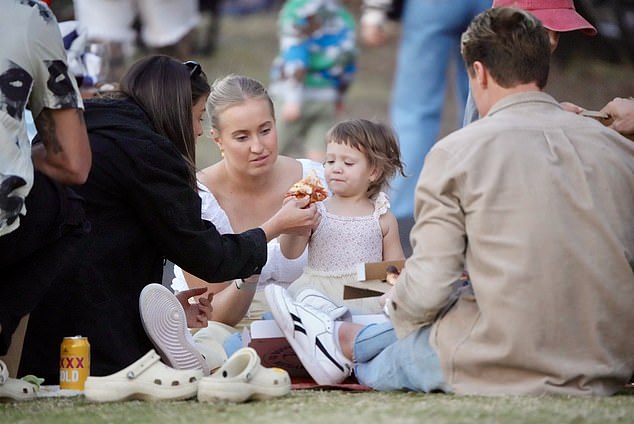 Matt and Annelyse brought a stack of pizzas to the seaside park, while friends brought bags of food and drinks, with Annelyse hand-feeding Posy