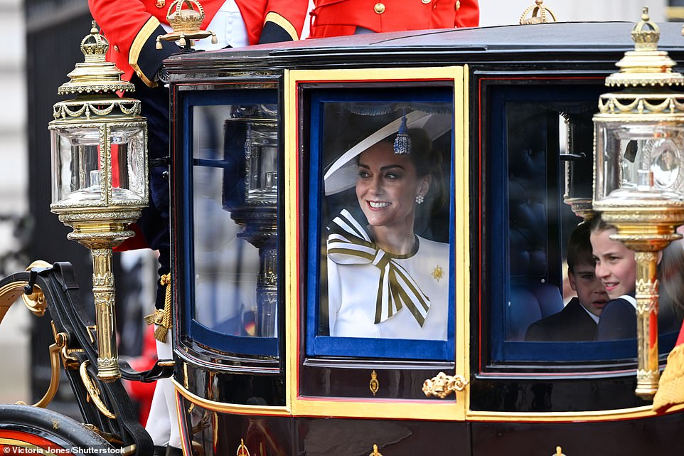 The Princess of Wales smiles while travelling with her children from Buckingham Palace this morning