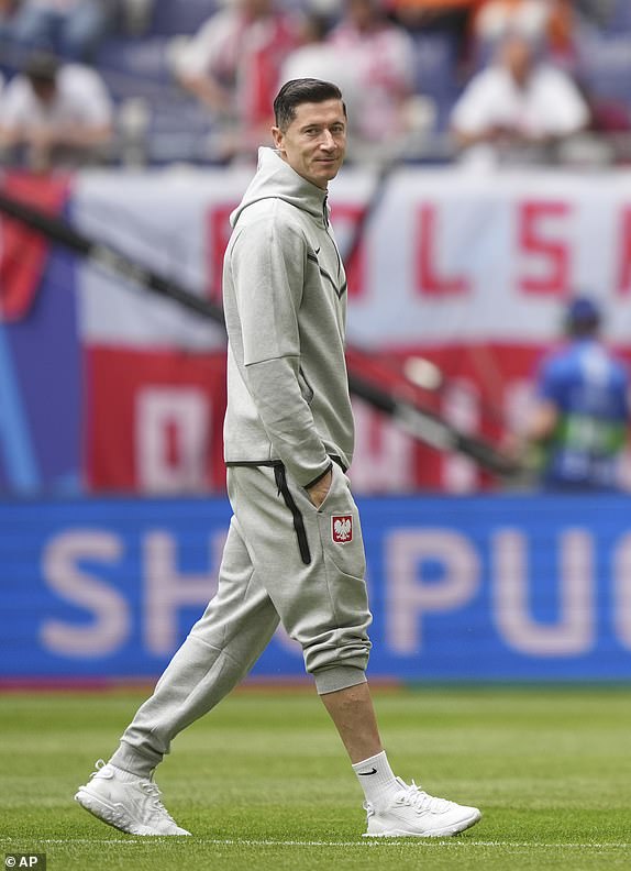 Poland's Robert Lewandowski walks on the pitch prior to the Group D match between Poland and the Netherlands at the Euro 2024 soccer tournament in Hamburg, Germany, Sunday, June 16, 2024. (AP Photo/Ebrahim Noroozi)