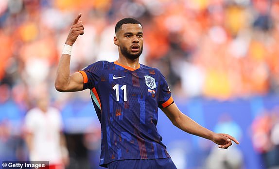 HAMBURG, GERMANY - JUNE 16: Cody Gakpo of the Netherlands celebrates scoring his team's first goal to equalise during the UEFA EURO 2024 group stage match between Poland and Netherlands at Volksparkstadion on June 16, 2024 in Hamburg, Germany.   (Photo by Julian Finney/Getty Images)