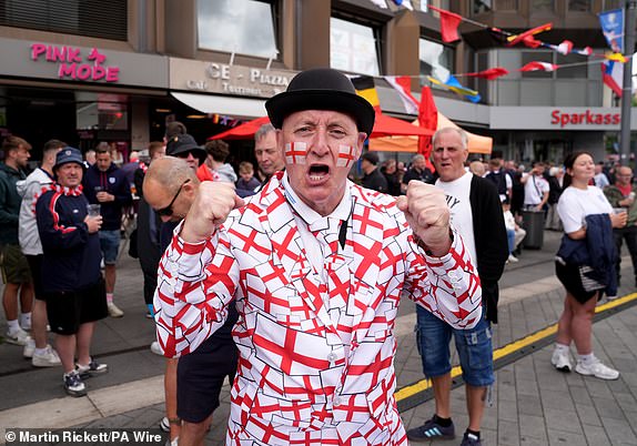 England fans in Heinrich-Konig-Platz in Gelsenkirchen ahead of the UEFA Euro 2024 Group C match at the Arena AufSchalke in Gelsenkirchen, Germany. Picture date: Sunday June 16, 2024. PA Photo. See PA Story SOCCER England. Photo credit should read: Martin Rickett/PA Wire.RESTRICTIONS: Use subject to FA restrictions. Editorial use only. Commercial use only with prior written consent of the FA. No editing except cropping.