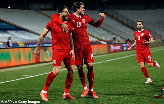 Serbia's Aleksandar Mitrovic celebrates his goal with Dusan Vlahovic during the FIFA World Cup Qatar 2022 qualification football match between Serbia and Ireland, at the Rajko Mitic Stadium, in Belgrade, Serbia on March 24, 2021. (Photo by PEDJA MILOSAVLJEVIC / AFP) (Photo by PEDJA MILOSAVLJEVIC/AFP via Getty Images)