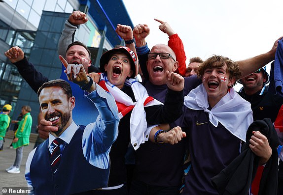 Soccer Football - Euro 2024 - Group C - Serbia v England - Arena AufSchalke, Gelsenkirchen, Germany - June 16, 2024 England fans with a cardboard cutout of England manager Gareth Southgate outside the stadium before the match REUTERS/Bernadett Szabo