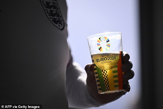 A supporter of England holds a reduced-strength beer prior to the UEFA Euro 2024 Group C football match between Serbia and England at the Arena AufSchalke in Gelsenkirchen on June 16, 2024. Gelsenkirchen has been declared high risk by the police due to fears Serbian ultras could clash with the tens of thousands of England fans that have made the trip to north-west Germany. (Photo by INA FASSBENDER / AFP) (Photo by INA FASSBENDER/AFP via Getty Images)