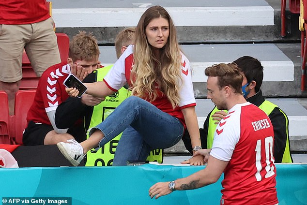 Eriksen's partner Sabrina Kvist rushed out on to the Copenhagen pitch to be beside him