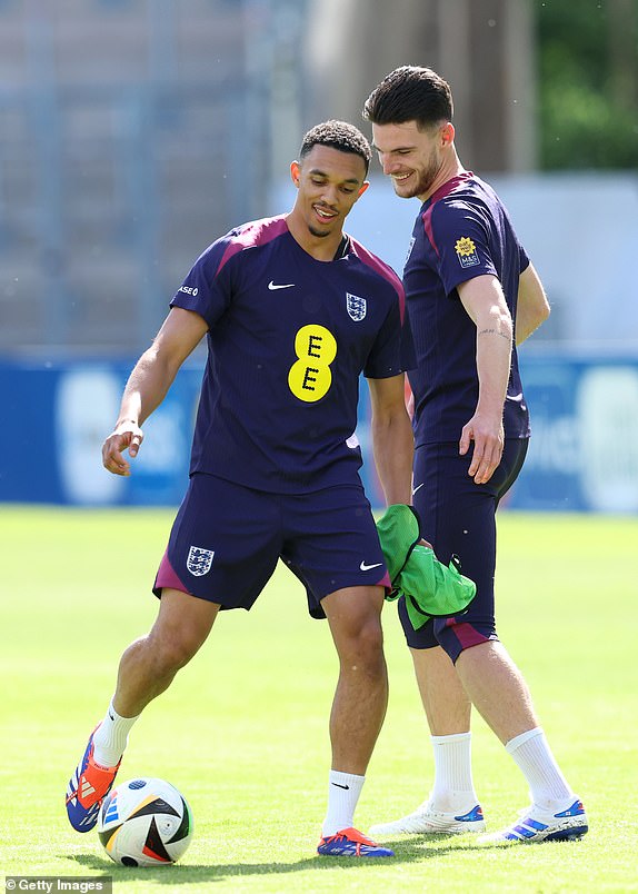 JENA, GERMANY - JUNE 11: Trent Alexander-Arnold and Declan Rice of England react during a training session at Ernst-Abbe-Sportfeld on June 11, 2024 in Jena, Germany. (Photo by Richard Pelham/Getty Images)
