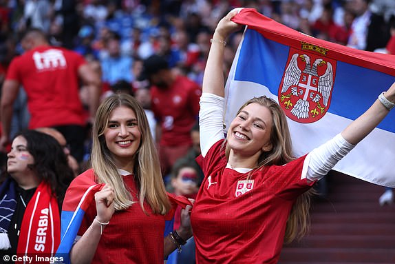 GELSENKIRCHEN, GERMANY - JUNE 16: Fans of Serbia pose for a photo prior to the UEFA EURO 2024 group stage match between Serbia and England at Arena AufSchalke on June 16, 2024 in Gelsenkirchen, Germany.   (Photo by Lars Baron/Getty Images)