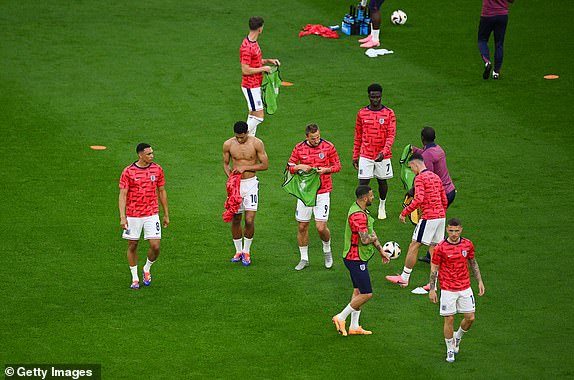 GELSENKIRCHEN, GERMANY - JUNE 16: Jude Bellingham of England adjusts his training shirt during the warm up prior to the UEFA EURO 2024 group stage match between Serbia and England at Arena AufSchalke on June 16, 2024 in Gelsenkirchen, Germany.   (Photo by Matthias Hangst/Getty Images)