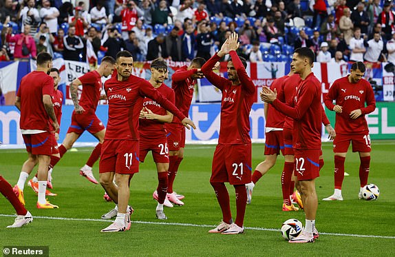 Soccer Football - Euro 2024 - Group C - Serbia v England - Arena AufSchalke, Gelsenkirchen, Germany - June 16, 2024 Serbia's Mijat Gacinovic and teammates during the warm up before the match REUTERS/Wolfgang Rattay