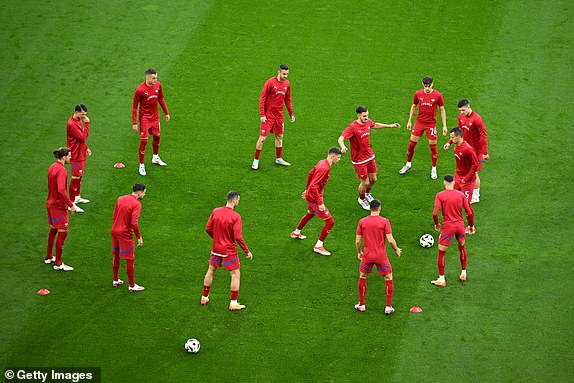 GELSENKIRCHEN, GERMANY - JUNE 16: The players of Serbia warm up prior to the UEFA EURO 2024 group stage match between Serbia and England at Arena AufSchalke on June 16, 2024 in Gelsenkirchen, Germany.   (Photo by Matthias Hangst/Getty Images)
