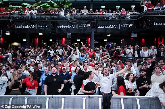 England fans celebrate after Jude Bellingham scores the opening goal of the game as they watch a screening at the 4theFans Greenwich Fan Park in London of the UEFA Euro 2024 Group C match between Serbia and England. Picture date: Sunday June 16, 2024. PA Photo. See PA story SOCCER England. Photo credit should read: Zac Goodwin/PA Wire. RESTRICTIONS: Use subject to restrictions. Editorial use only, no commercial use without prior consent from rights holder.