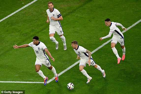 GELSENKIRCHEN, GERMANY - JUNE 16: Jude Bellingham of England celebrates scoring his team's first goal with teammates Harry Kane, Kieran Trippier and Phil Foden during the UEFA EURO 2024 group stage match between Serbia and England at Arena AufSchalke on June 16, 2024 in Gelsenkirchen, Germany.   (Photo by Matthias Hangst/Getty Images)