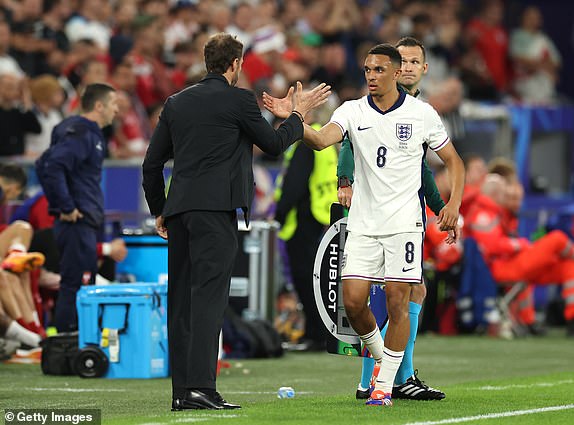 GELSENKIRCHEN, GERMANY - JUNE 16: Gareth Southgate, Head Coach of England, shakes hands with Trent Alexander-Arnold of England as he comes off after being substituted during the UEFA EURO 2024 group stage match between Serbia and England at Arena AufSchalke on June 16, 2024 in Gelsenkirchen, Germany.   (Photo by Richard Pelham/Getty Images)