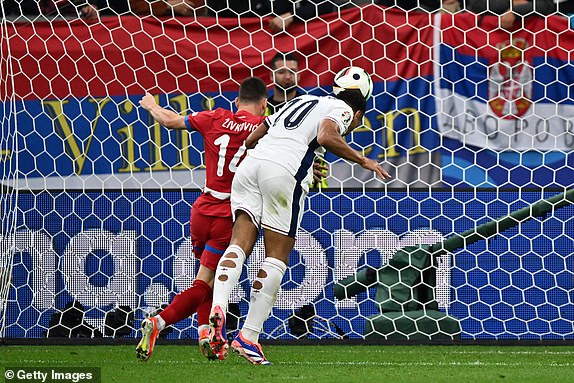 GELSENKIRCHEN, GERMANY - JUNE 16:  Jude Bellingham of England scoring the first goal during the UEFA EURO 2024 group stage match between Serbia and England at Arena AufSchalke on June 16, 2024 in Gelsenkirchen, Germany.(Photo by Sebastian Frej/MB Media/Getty Images)