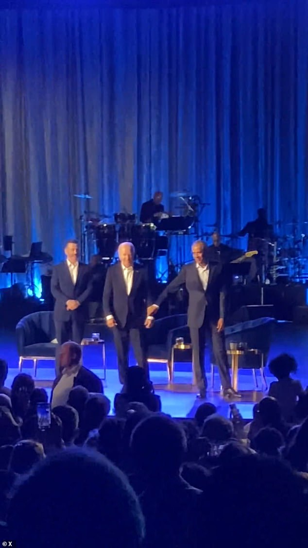 Obama seen giving Biden's arm a gentle tug and leading him off the stage after the president freezes during the applause at a fundraiser in Los Angeles