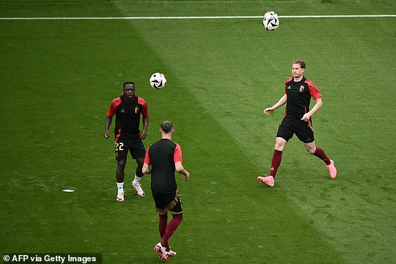 Belgium's forward #22 Jeremy Doku and Belgium's midfielder #07 Kevin De Bruyne warm up ahead of the UEFA Euro 2024 Group E football match between Belgium and Slovakia at the Frankfurt Arena in Frankfurt am Main on June 17, 2024. (Photo by Angelos Tzortzinis / AFP) (Photo by ANGELOS TZORTZINIS/AFP via Getty Images)