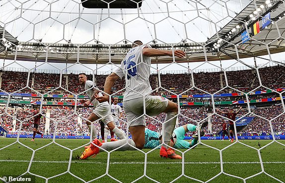 Soccer Football - Euro 2024 - Group E - Belgium v Slovakia - Frankfurt Arena, Frankfurt, Germany - June 17, 2024 Slovakia's David Hancko saves a shot from Belgium's Johan Bakayoko REUTERS/Lee Smith