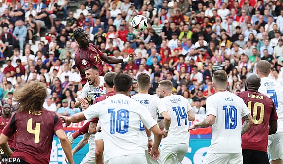 epa11418441 Amadou Onana (up) of Belgium goes for a header during the UEFA EURO 2024 group E match between Belgium and Slovakia, in Frankfurt Main, Germany, 17 June 2024.  EPA/ABEDIN TAHERKENAREH