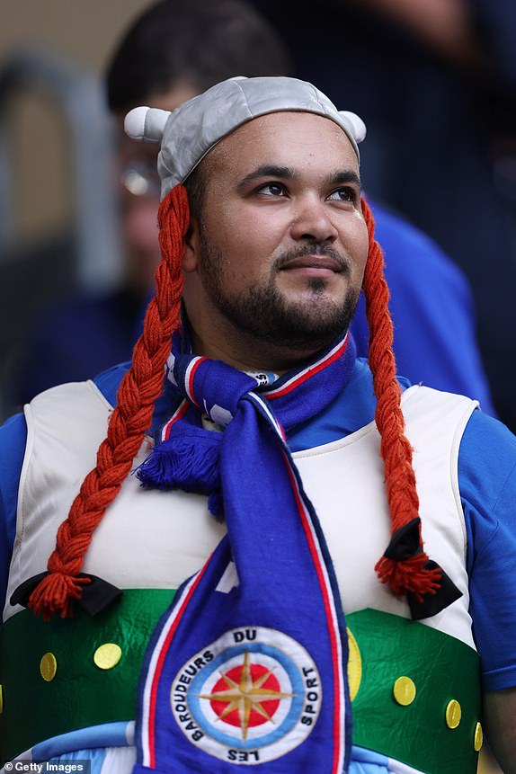 DUSSELDORF, GERMANY - JUNE 17: A fan of France, wearing fancy dress, looks on as he enjoys the pre match atmosphere prior to the UEFA EURO 2024 group stage match between Austria and France at DÃ¼sseldorf Arena on June 17, 2024 in Dusseldorf, Germany. (Photo by Dean Mouhtaropoulos/Getty Images)