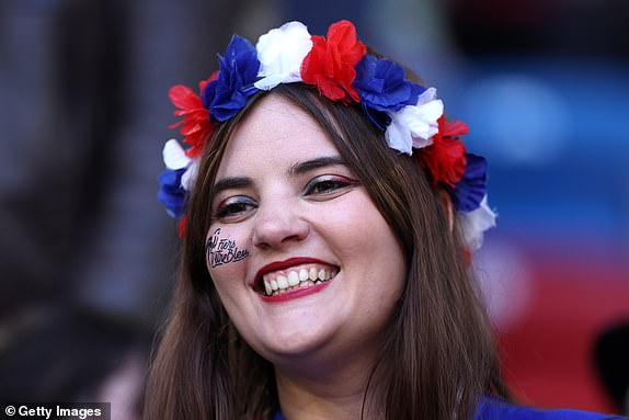 DUSSELDORF, GERMANY - JUNE 17: A fan of France, wearing a floral head piece, looks on as she enjoys the pre match atmosphere prior to the UEFA EURO 2024 group stage match between Austria and France at DÃ¼sseldorf Arena on June 17, 2024 in Dusseldorf, Germany. (Photo by Dean Mouhtaropoulos/Getty Images)