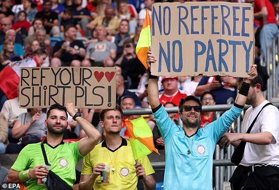 epa11418657 Spectators supporting referees hold placards the UEFA EURO 2024 group D soccer match between Austria and France, in Dusseldorf, Germany, 17 June 2024.  EPA/FRIEDEMANN VOGEL